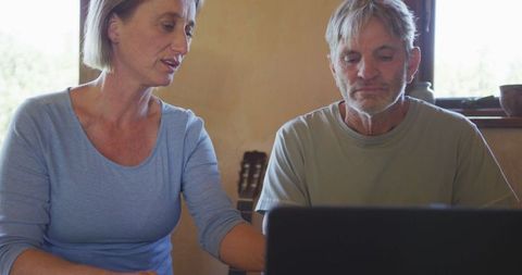 Senior Couple Using Laptop, Engaged in Technology at Home