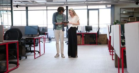 Colleagues collaborating in open-plan modern office