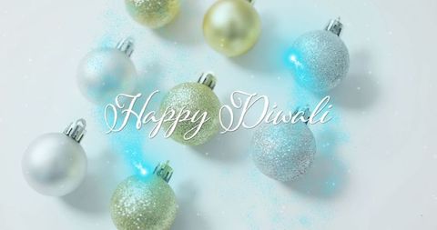 Glittery ornaments with happy diwali greeting