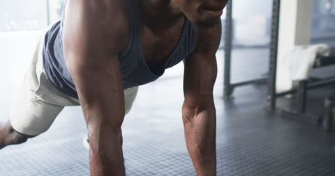 Man Engaging in Weightlifting Workout at Gym