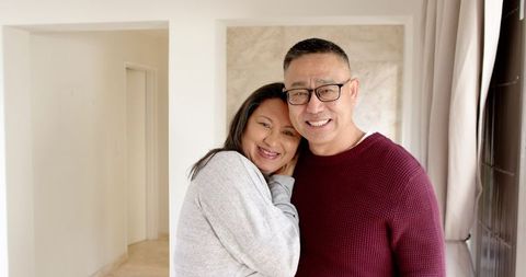 Happy Senior Couple Embracing in Cozy Home Setting