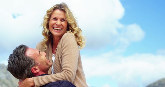 Happy Mature Couple Embracing Outdoors Under Blue Sky - Download Free Stock Images Pikwizard.com