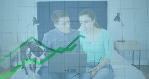 Caucasian Couple Analyzing Financial Data with Graphic Overlay