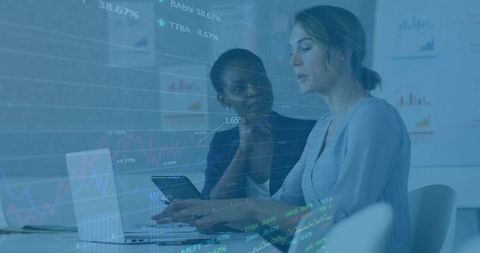 Female professionals analyzing business data in modern office