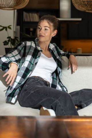 Young Woman Relaxing on Sofa in Cozy Home Interior