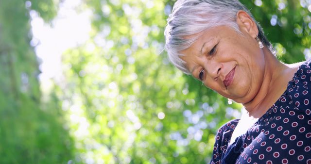 Content Middle-Aged Woman Relaxing Outdoors in Sunlight - Download Free Stock Images Pikwizard.com