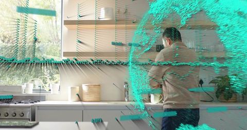 Man rinsing coffee mug at modern minimalist kitchen sink with turquoise ar data overlay
