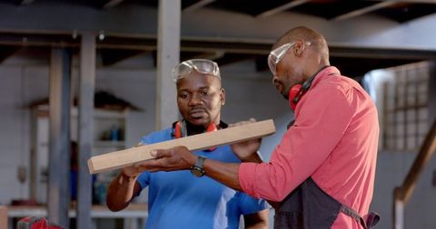 African american coworkers collaborating in woodshop