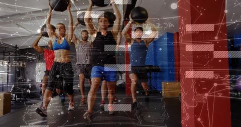 Group functional fitness lunging with medicine balls overhead and digital hud overlay