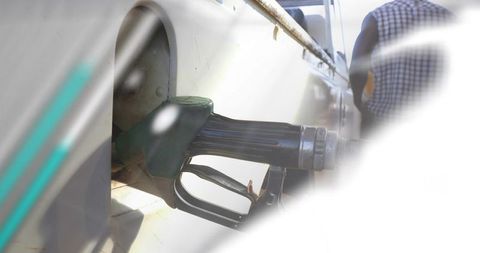 Man fueling van while woman checking phone with animated monthly fuel charts overlay
