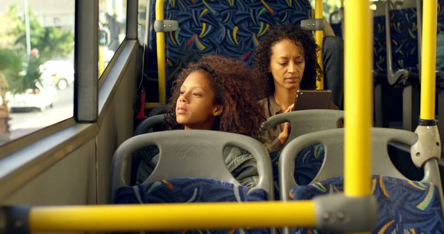 Two Women on Public Bus Making Use of Commute Time - Download Free Stock Images Pikwizard.com