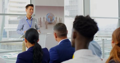 Confident Speaker Presenting at Business Seminar with Audience Engagement - Download Free Stock Images Pikwizard.com