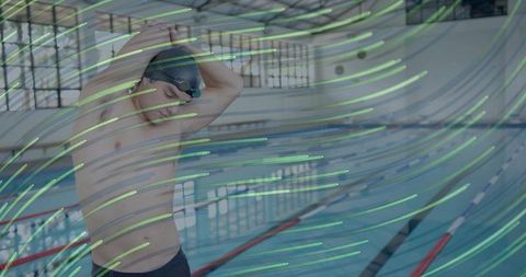 Male swimmer preparing for dive at indoor lap pool