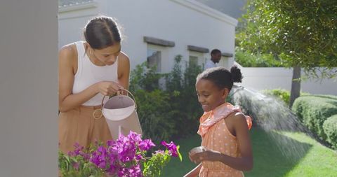 Mother and Daughter Gardening Together in Lush Backyard Setting