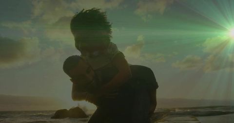 Couple Playfully Enjoying Romantic Sunset Walk by Ocean