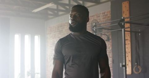 African American Athlete Training in Industrial Warehouse Gym