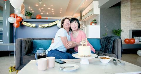 Joyful Senior Friends Celebrating Birthday with Cake and Balloons