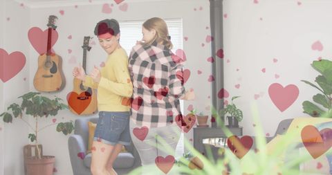 Joyful Couple Dancing with Heart Decorations