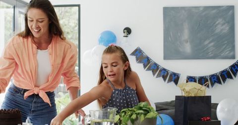 Mixed Race Mother and Daughter Preparing Birthday Celebration
