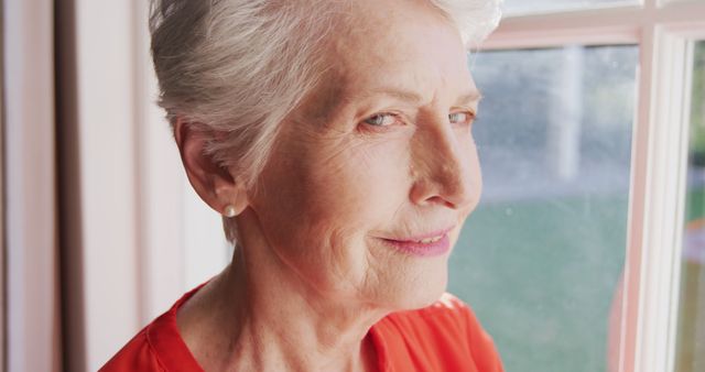 Senior Woman Smiling Next to Window - Download Free Stock Images Pikwizard.com