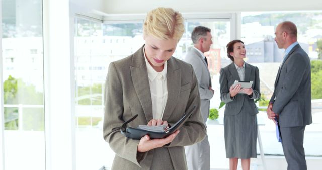 Professional Businesswoman Using Organizer in Modern Office - Download Free Stock Images Pikwizard.com