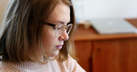 Woman with Glasses Concentrating in Home Setting - Download Free Stock Images Pikwizard.com
