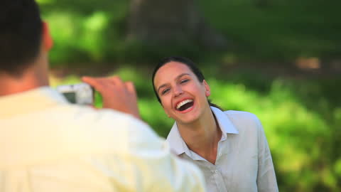 Woman Smiling for Camera in Sunlit Park