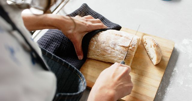 Close-Up of Woman Slicing Fresh Baguette on Wooden Cutting Board - Download Free Stock Images Pikwizard.com
