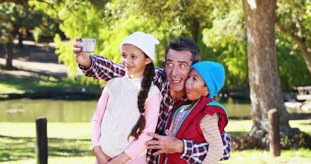 Father Taking Selfie with Children in Park on Bright Day - Download Free Stock Images Pikwizard.com