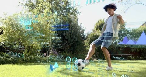 Balancing young man controlling soccer ball in sunlit backyard with AR finance HUD overlays
