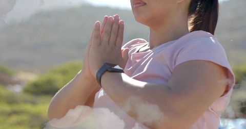 Serene Asian Woman Practicing Mindfulness Outdoors with Smartwatch