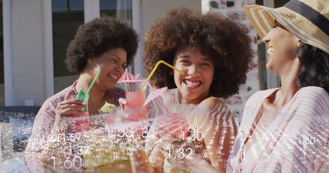 Laughing friends clinking pink cocktails on sunny patio wearing summer hats with numeric overlay