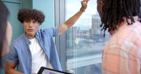 Young Professional Presenting Data in Modern Office