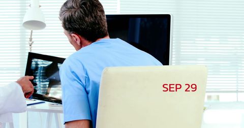 Doctors Analyzing X-Ray Results in Modern Clinic