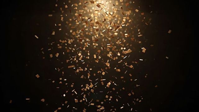 Shimmering Gold Confetti in Dark Ambient Light