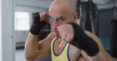 Focused boxer throwing punch with data overlay gym training concept for fitness tech