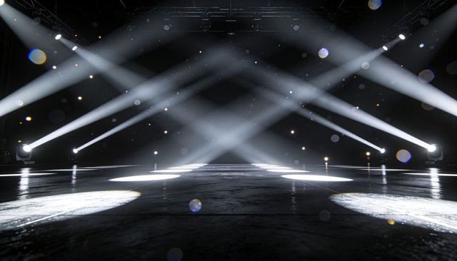 Dramatic empty stage with intersecting white spotlights, haze, truss and glossy floor