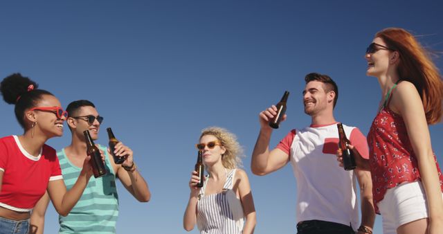 Group of Friends Enjoying Beverages Outdoors Under Blue Sky - Download Free Stock Images Pikwizard.com