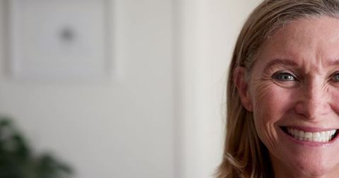 Smiling Woman in Minimalist Home Interior with Natural Light