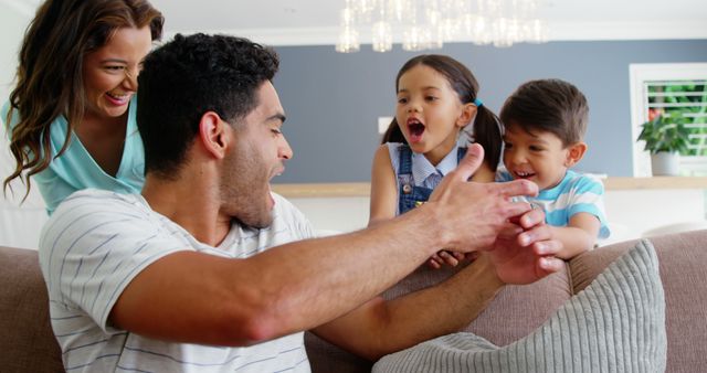 Family enjoying playful moment together at home - Download Free Stock Images Pikwizard.com