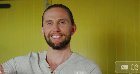 Smiling Bearded Man with Digital Interface on Yellow Background