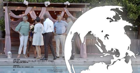 Multigenerational group gathering by backyard pool under draped pergola holding bouquet