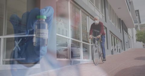 Senior man cycling wearing mask with covid-19 vaccine in foreground