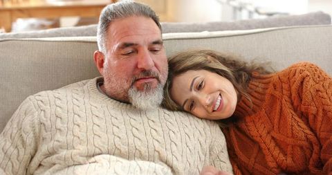 Couple Relaxing on Sofa Wearing Knit Sweaters, Cozy Home Comfort and Affection