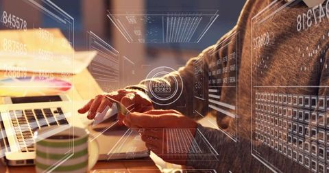 Man typing on laptop holding card with augmented reality financial hud and holographic ui