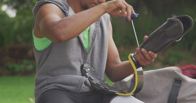 Athlete Adjusting Prosthetic Leg Outdoors for Training - Download Free Stock Images Pikwizard.com