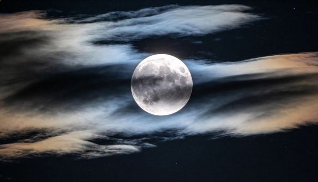 Full Moon Illuminating Wispy Clouds and Lunar Surface Details Over Night Sky