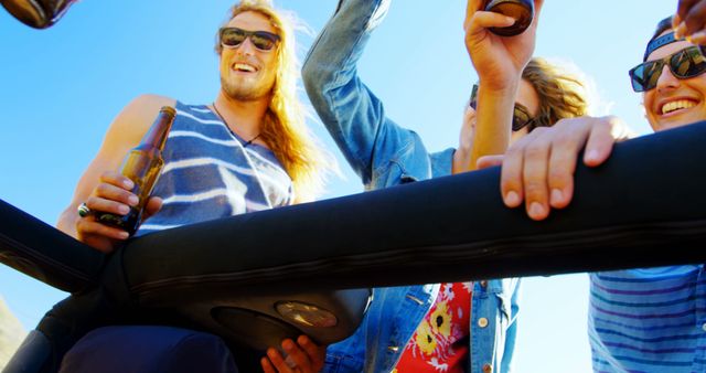 Friends Enjoying a Road Trip Celebrating with Drinks in an Open-Top Car - Download Free Stock Images Pikwizard.com