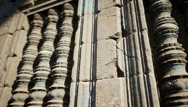 Ancient temple carved stone balusters, fluted pilasters, weathered patina, deep shadows