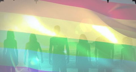 Silhouettes of Unity with Rainbow Flag Symbolizing Diversity